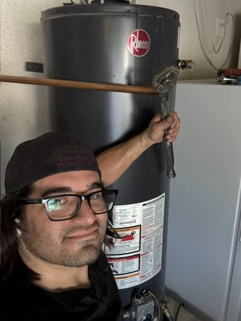 Gabriel Ruiz, owner of Royalty Plumbing Inc, with a water heater